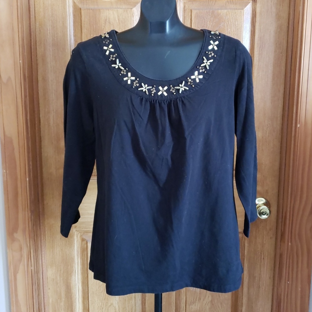 Black top with gold accents.
